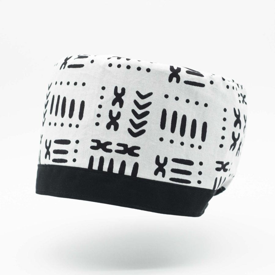 Traditional Rasta hat for dreadlocks in white African wax with modern black patterns with a black cotton headband at the bottom of the hat with black cotton lining