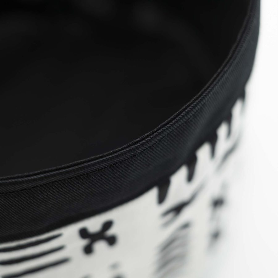 Traditional Rasta hat for dreadlocks in white African wax with modern black patterns with a black cotton headband at the bottom of the hat with black cotton lining