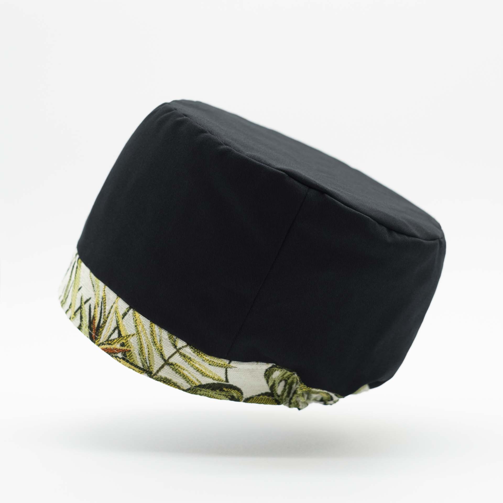 Traditional Rasta hat for dreadlocks in black cotton accompanied by a thin headband in tropical jungle weaving at the bottom of the hat with black cotton lining