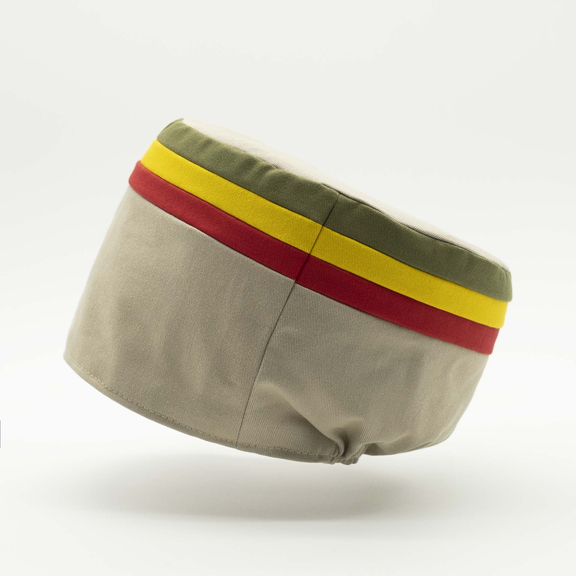 Rasta crown without visor. Beige cotton with red gold and green stripes at the top of the tam.