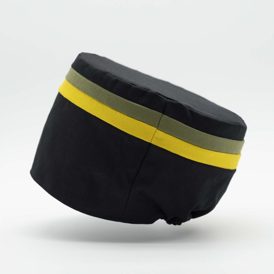 Rasta hat without visor in black cotton with two thin yellow and green stripes on the top of the tam Jamaica colors