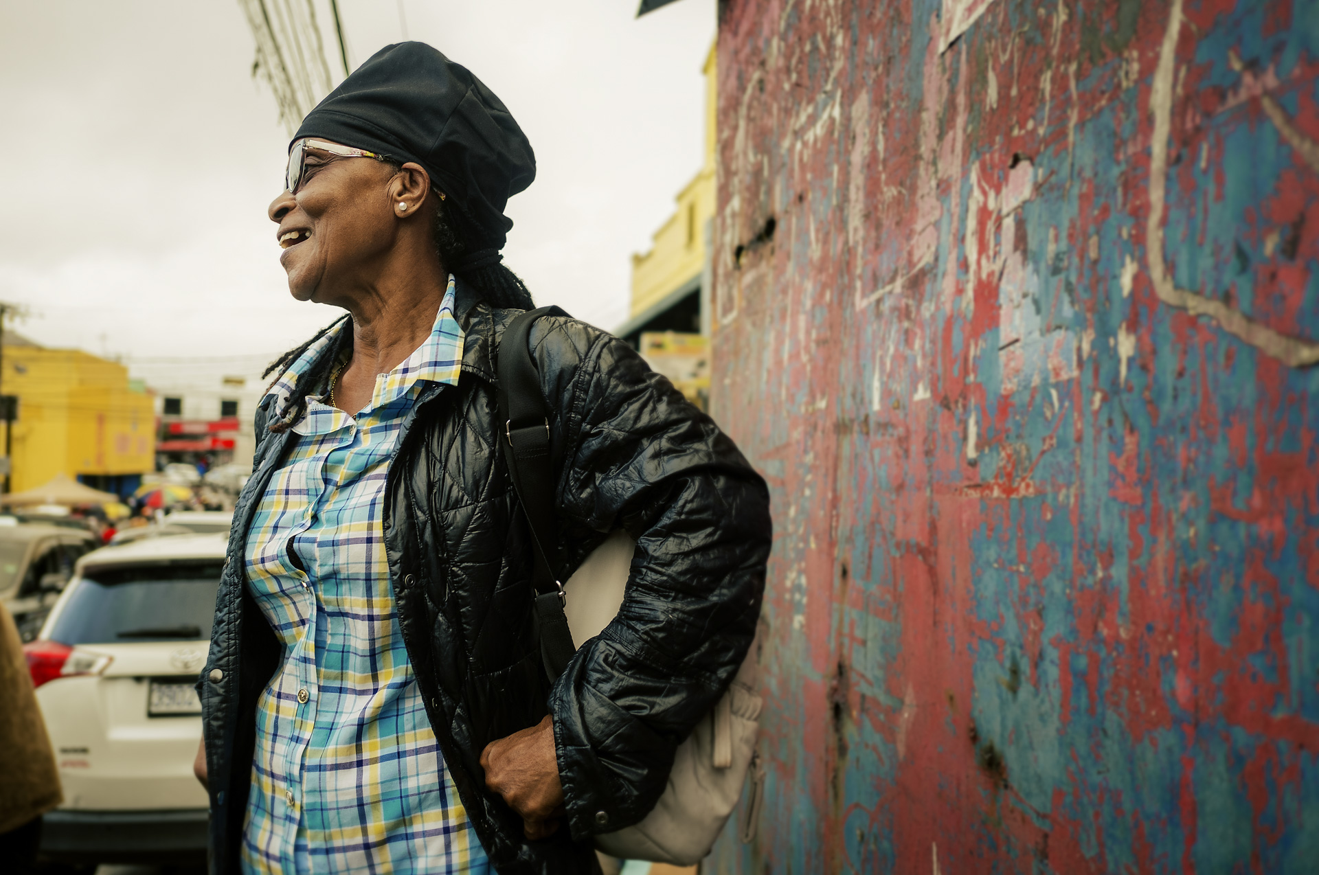 Jamaican lady in the street with a black dreadlocks hat with no visor