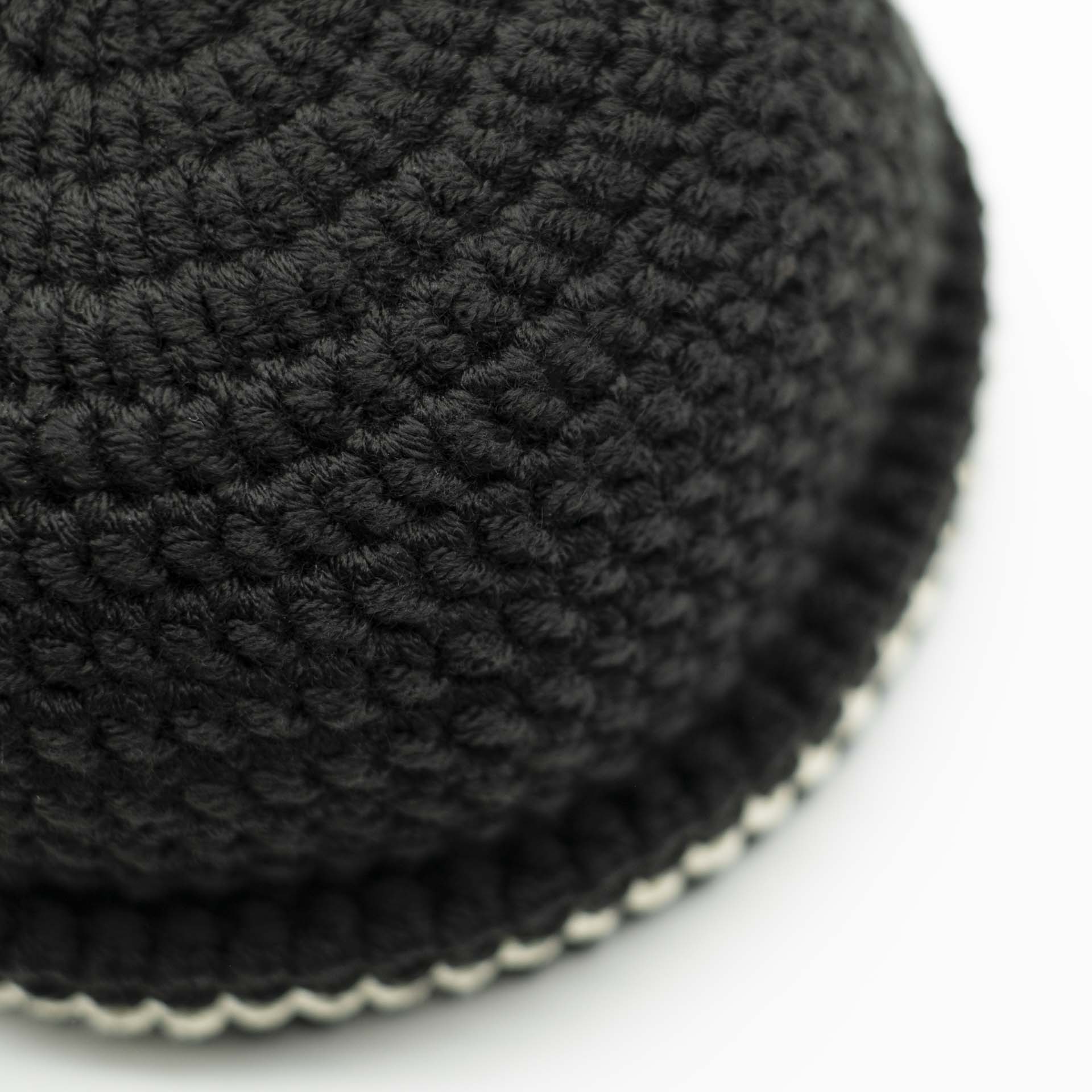 Beanie wool Rasta hat in black with a thin cream band on the hem