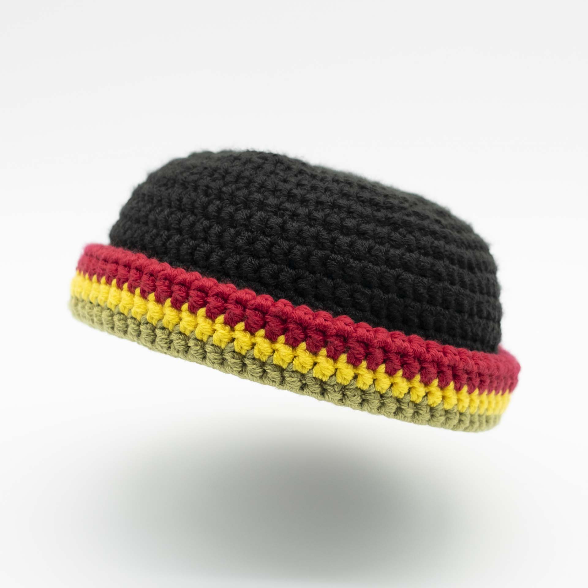 Beanie wool hat in black with a thin green yellow red hem