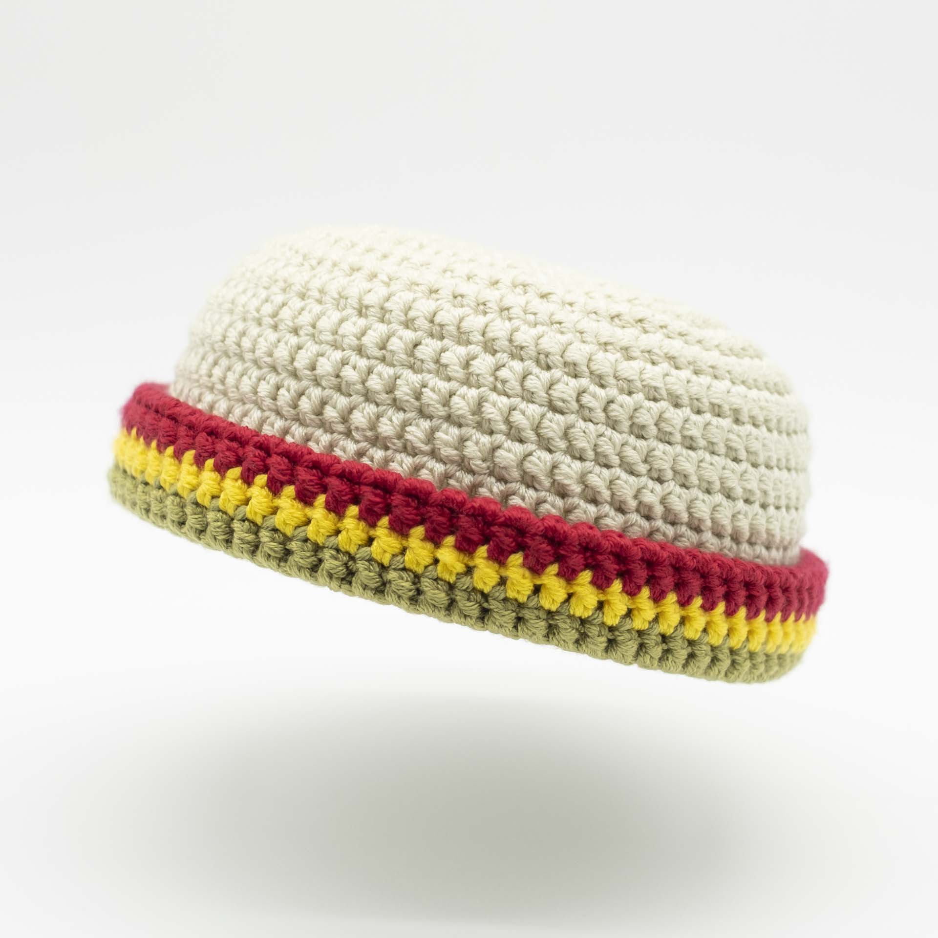 Beanie wool hat in black with a thin green yellow red hem