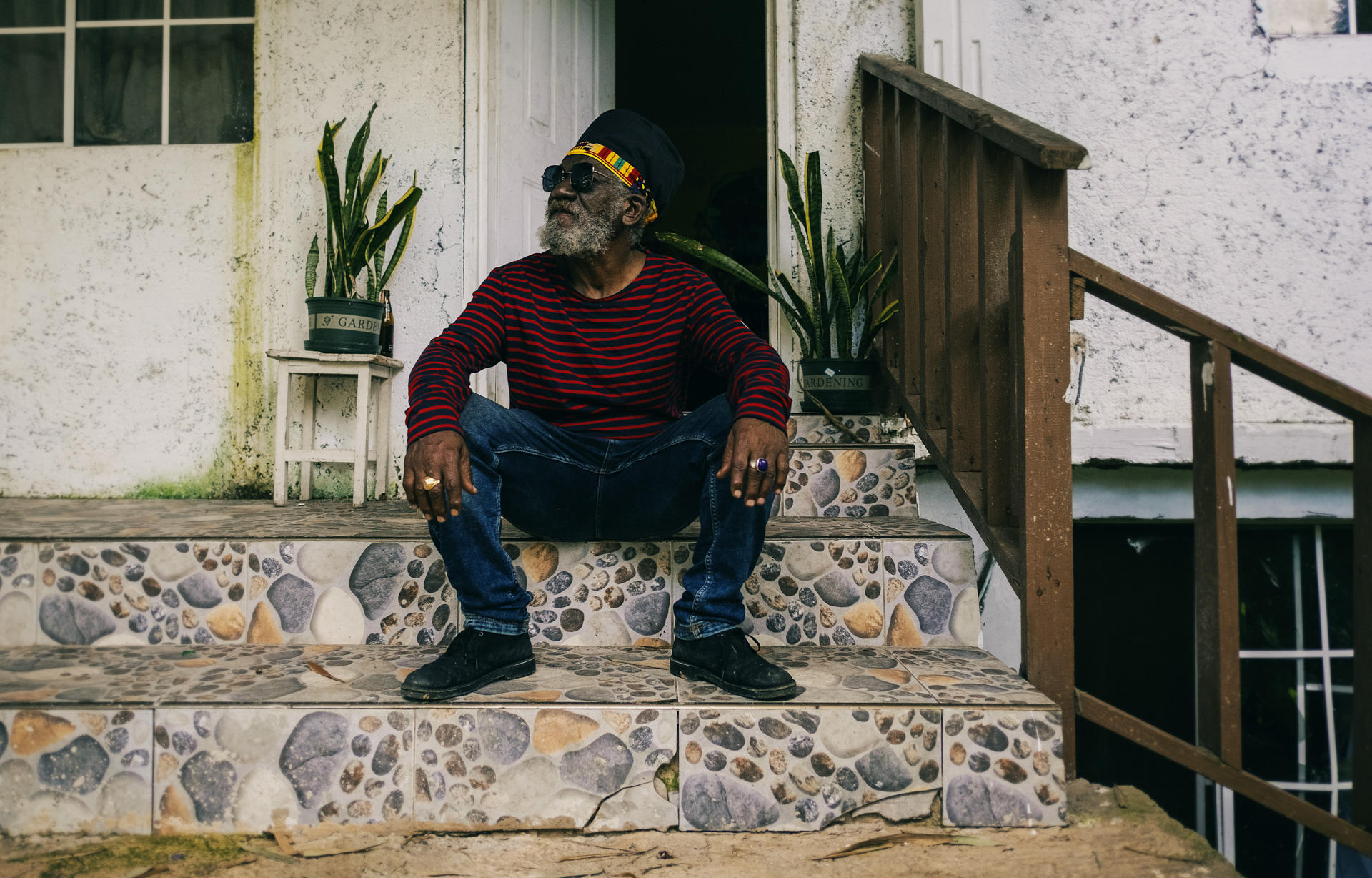 Winston McAnuff wearing a dreadlocks crown in his house in Jamaica