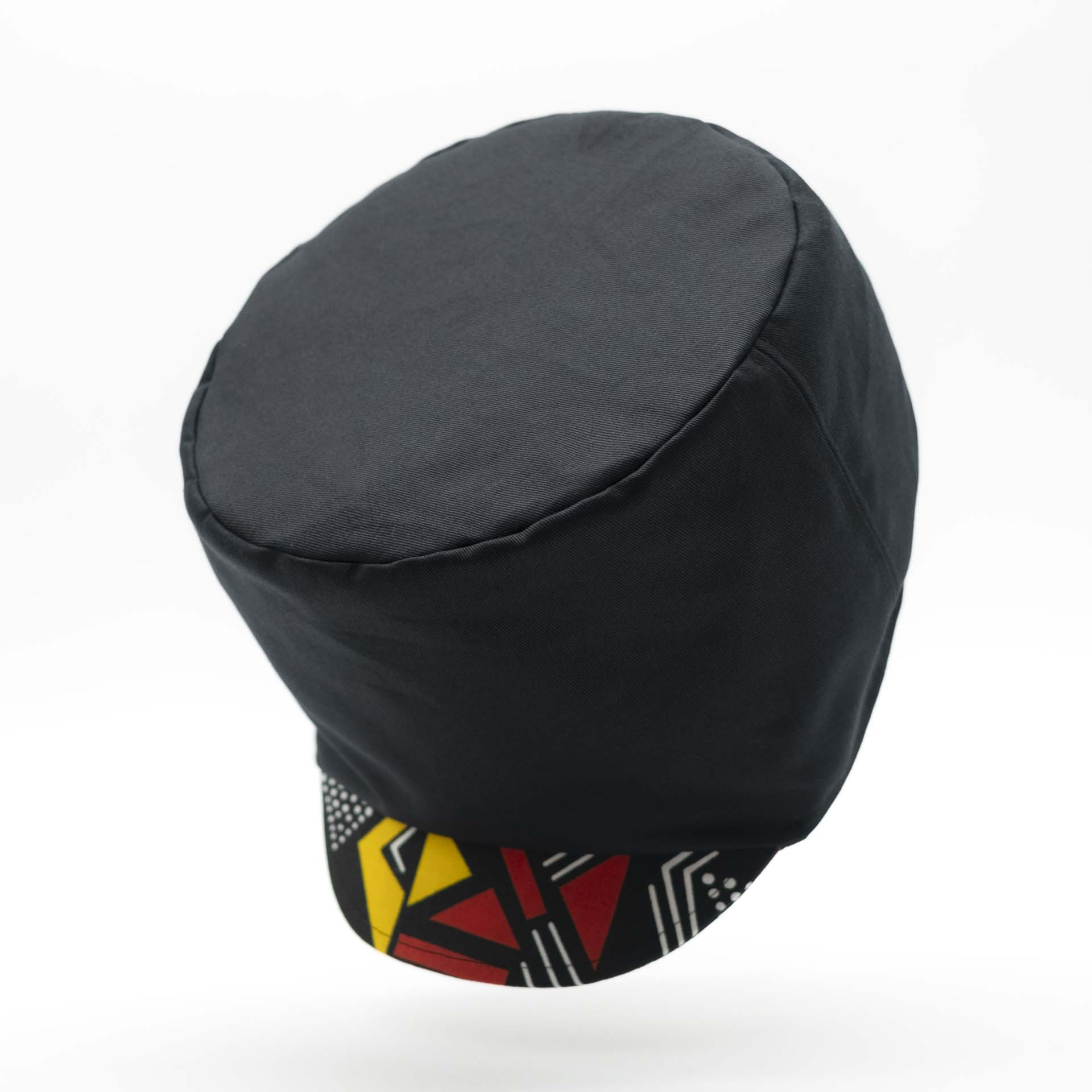 Rasta hat in black cotton with visor in African wax yellow and red geometric patterns for dreadlocks black lining