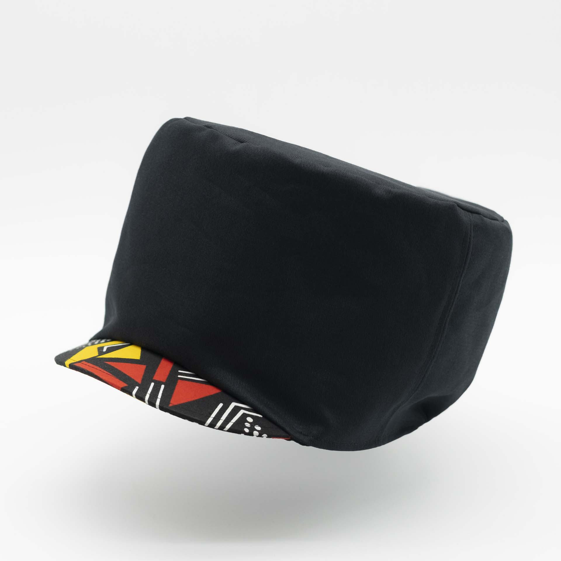 Rasta hat in black cotton with visor in African wax yellow and red geometric patterns for dreadlocks black lining