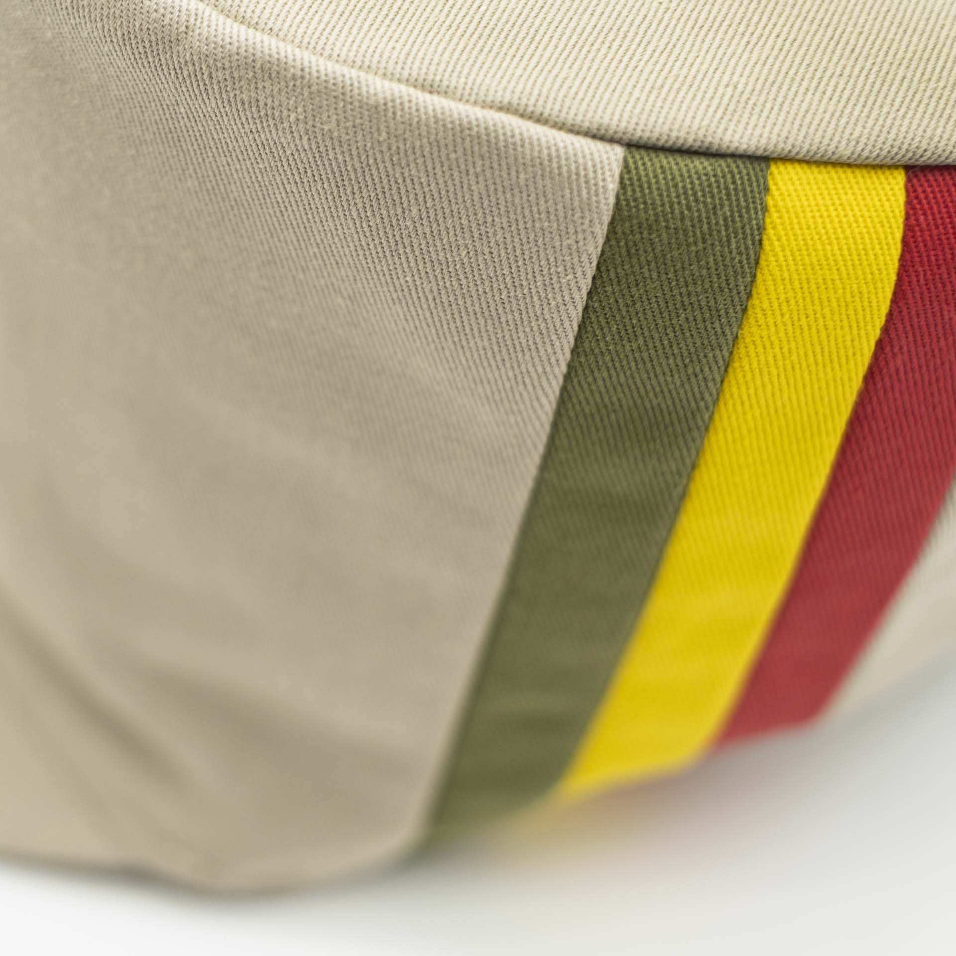 Rasta hat for dreadlocks in beige cotton with three green yellow red stripes on one side of the hat and ecru lining