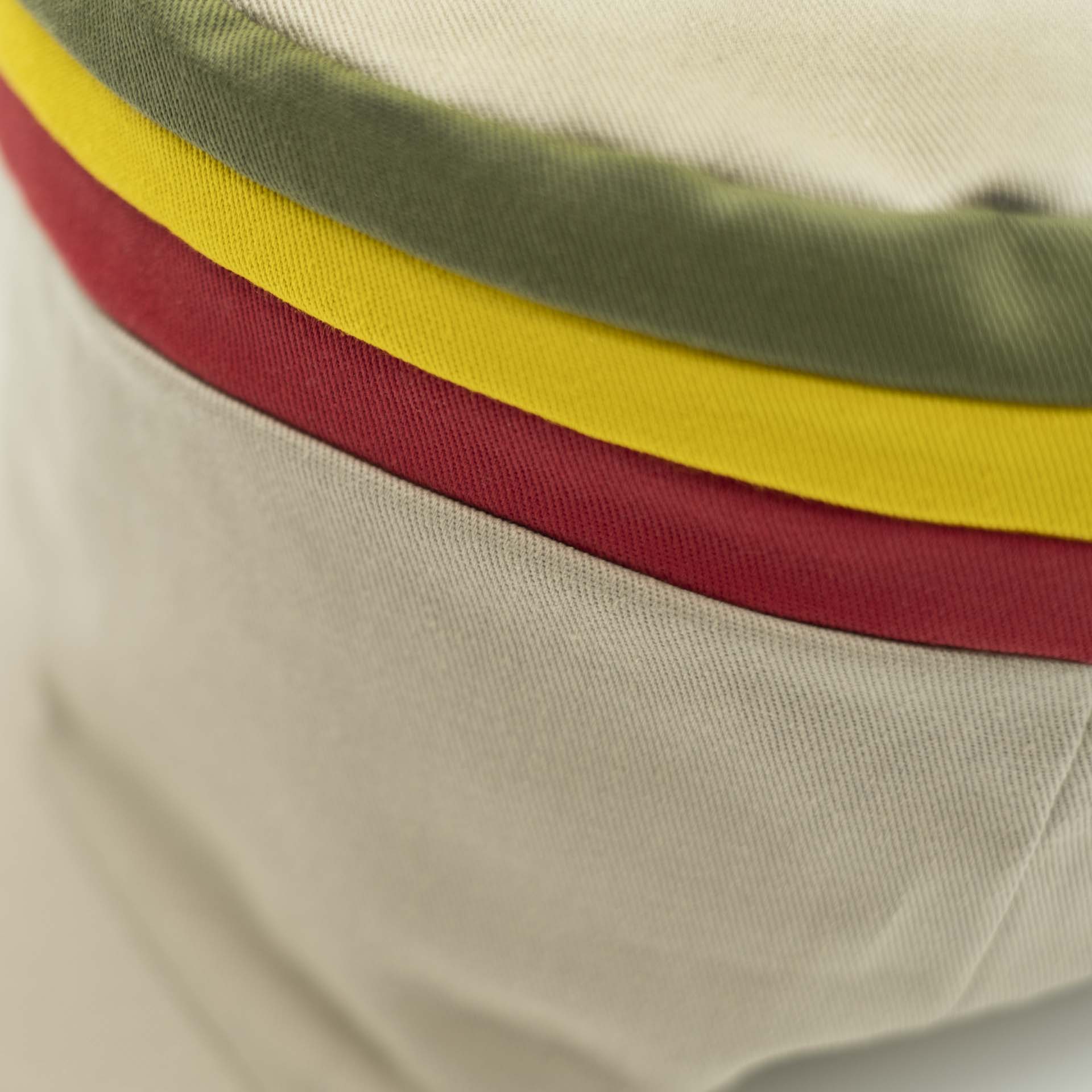 Rasta cap with visor for dreadlocks in beige cotton with three red yellow green stripes on the top of the hat and ecru lining