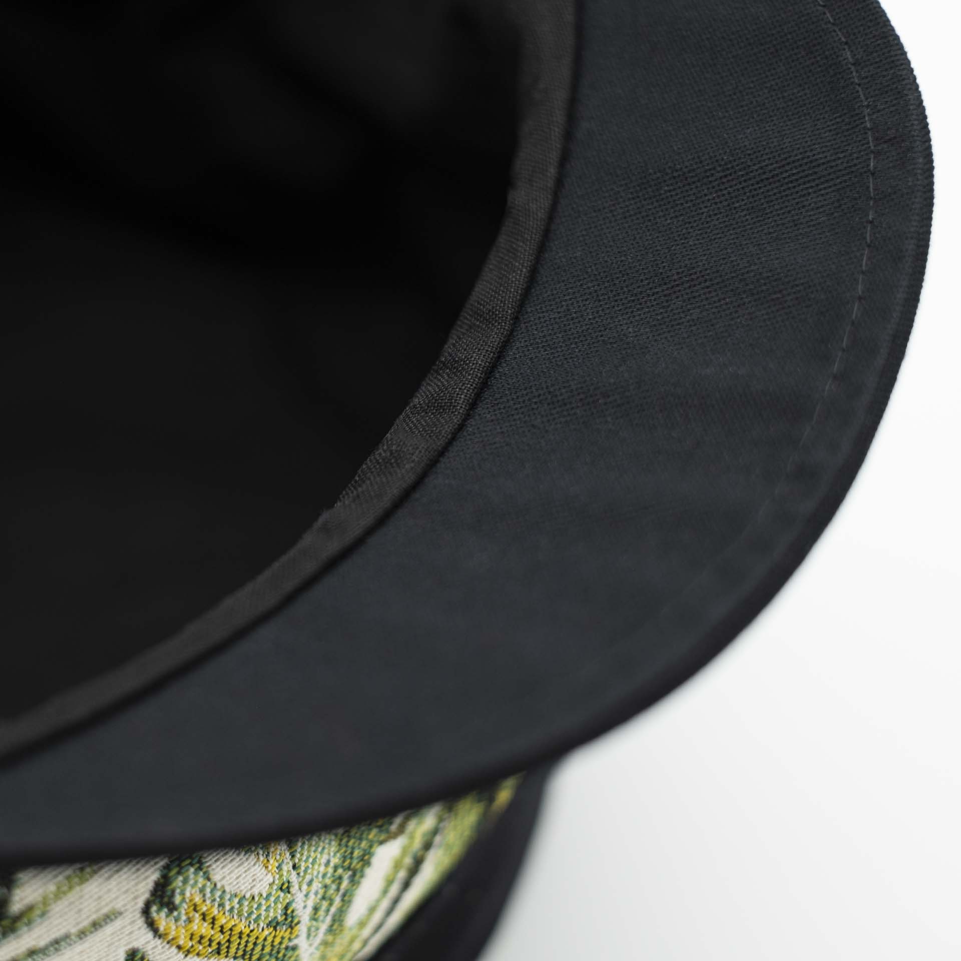 Rasta cap with dreadlocks in black cotton with a front pant in tropical jungle weave black lining