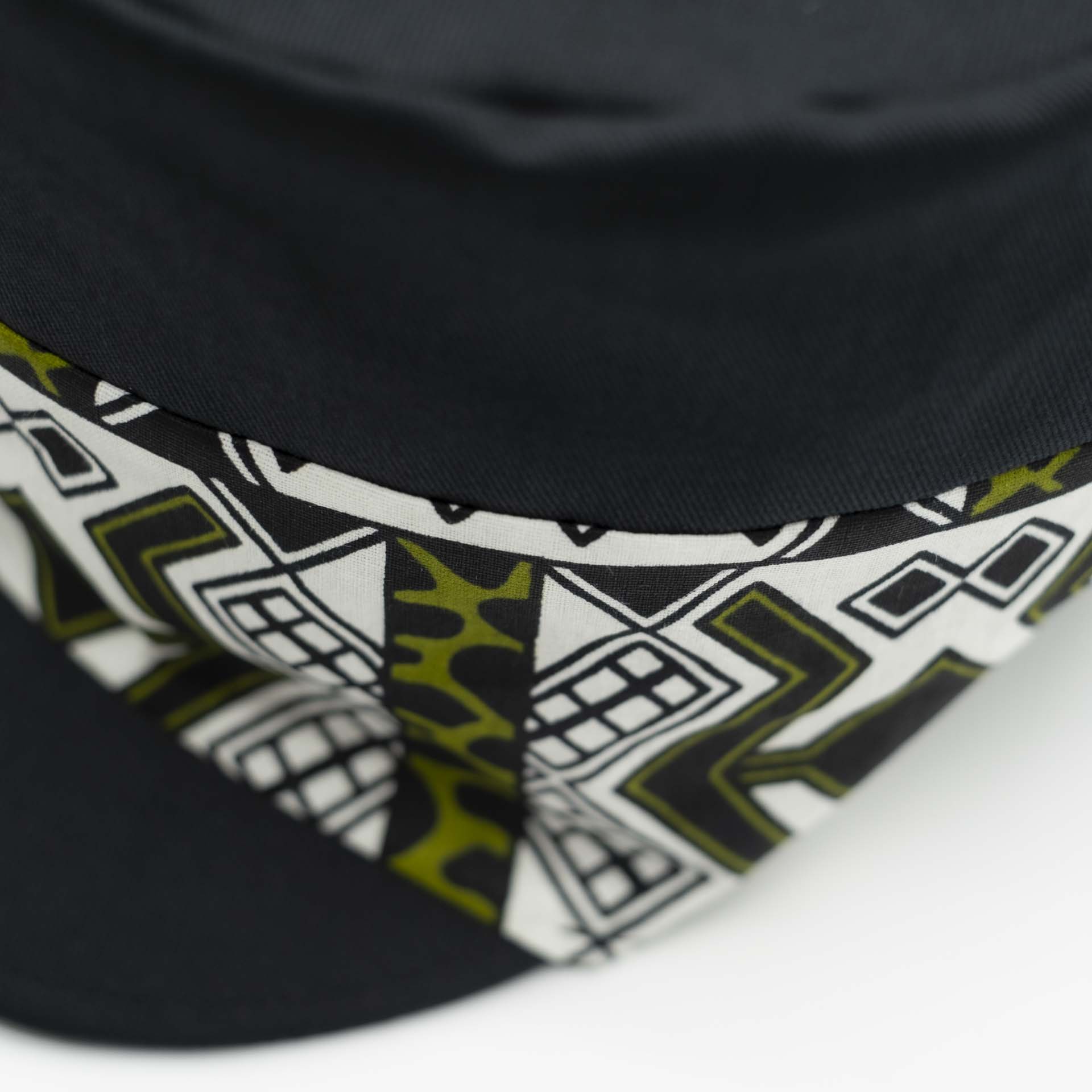 Rasta cap with dreadlocks in black cotton with a front pant facing in wax ethnic patterns black lining