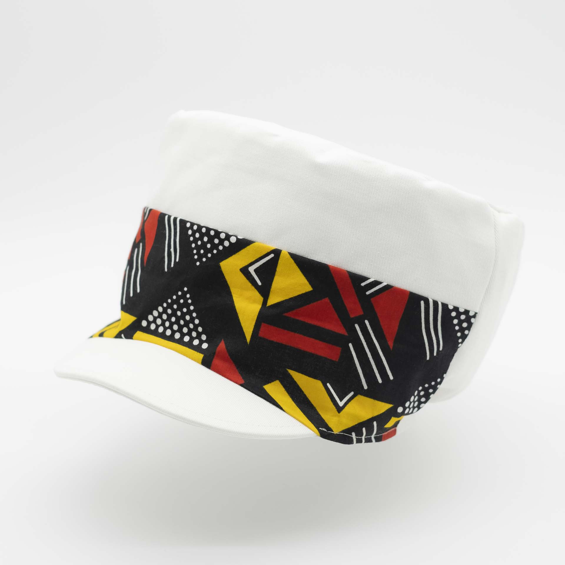 Rasta cap with dreadlocks in white cotton with a front pant facing in yellow and red geometric pattern wax with white lining