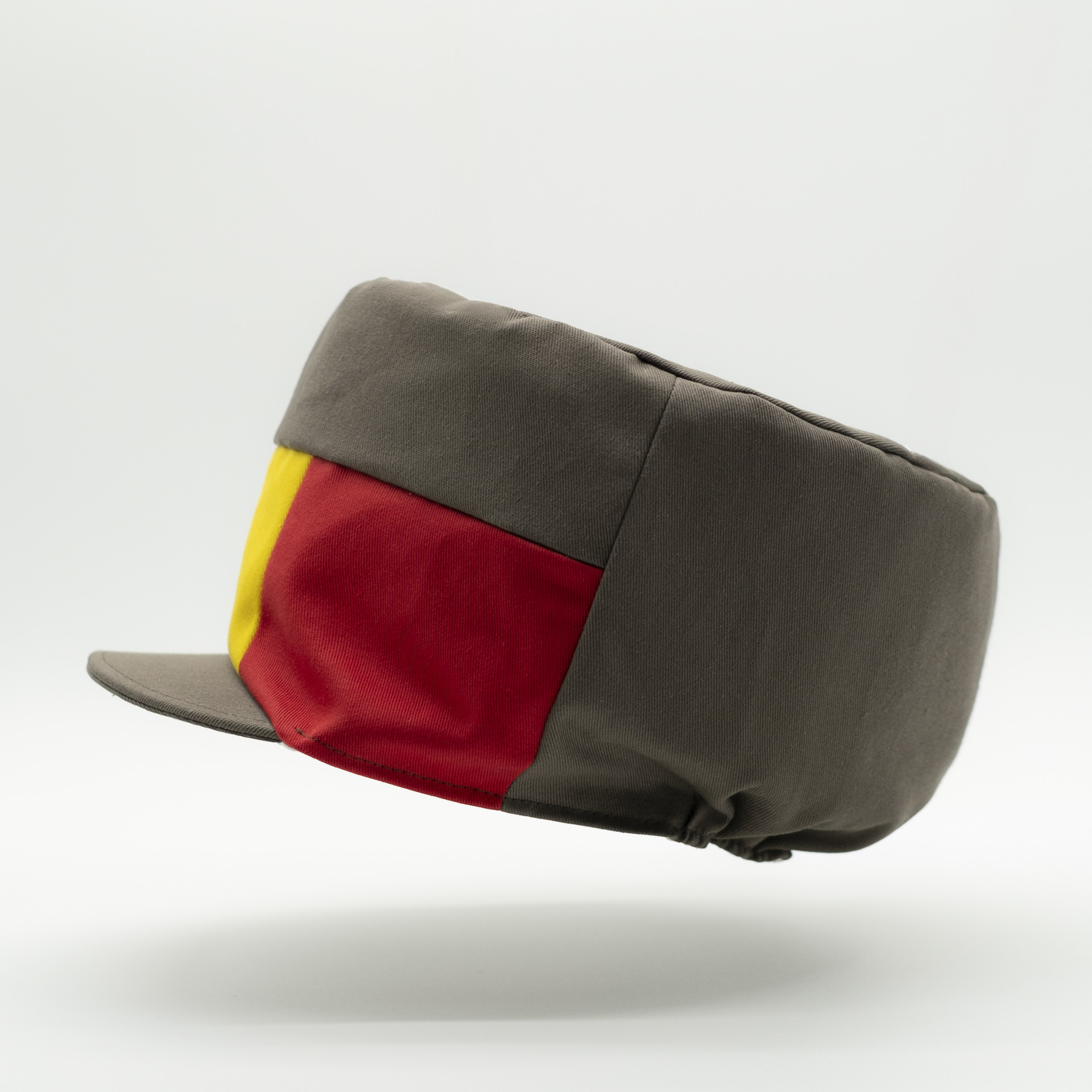 Dreadlocks hat crown with visor in brown fabric with a red yellow green panel on the front and a raw lining