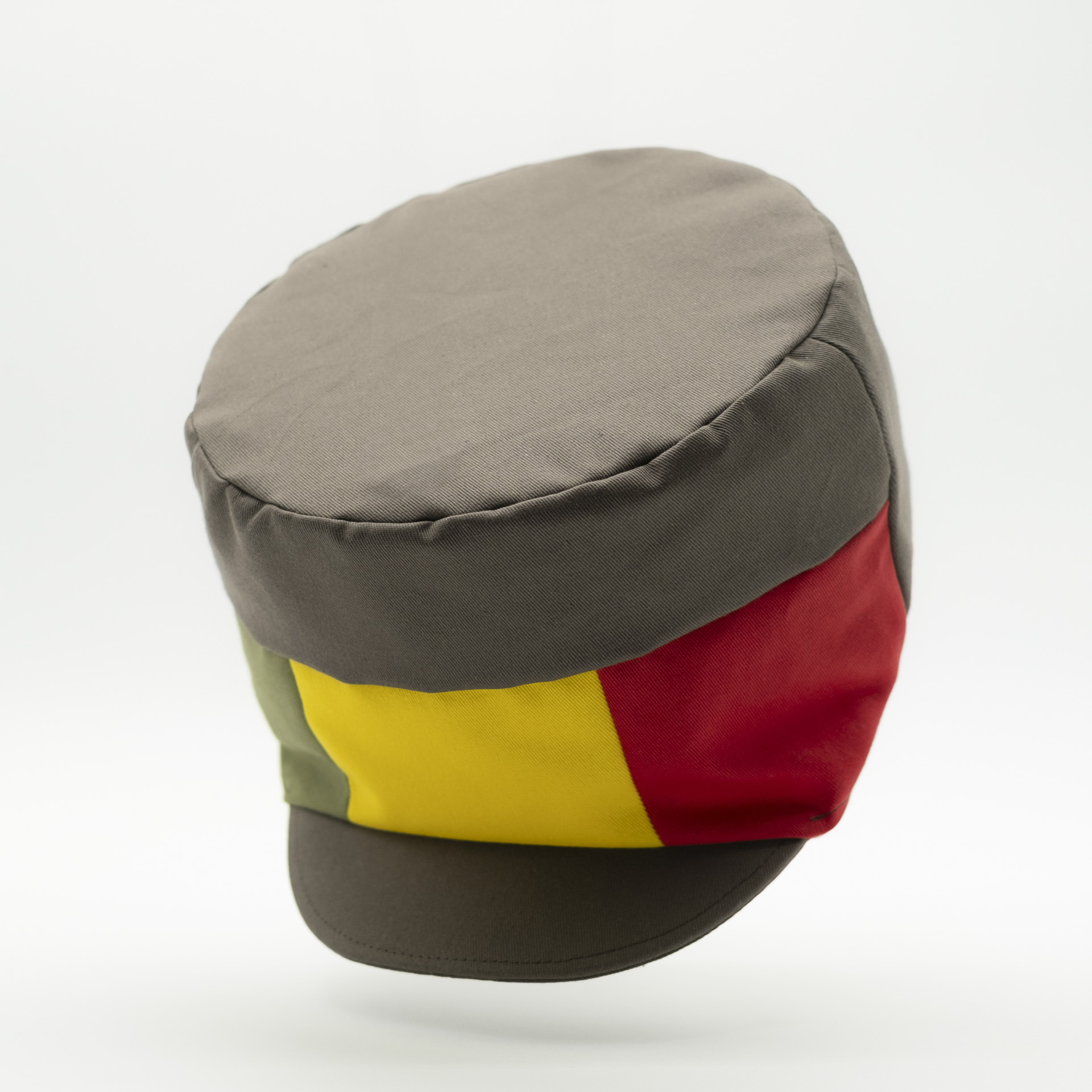 Dreadlocks hat crown with visor in brown fabric with a red yellow green panel on the front and a raw lining