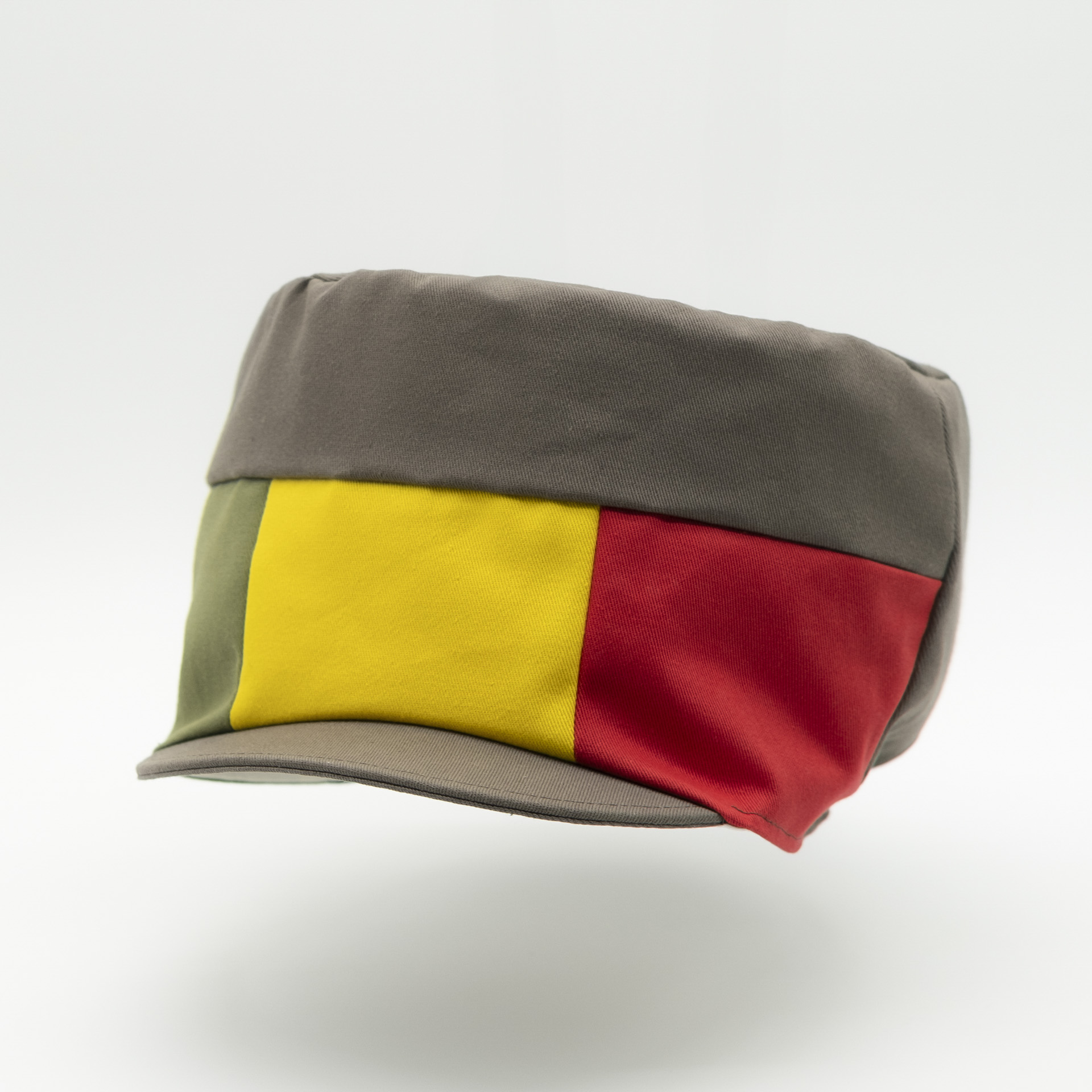 Dreadlocks hat crown with visor in brown fabric with a red yellow green panel on the front and a raw lining