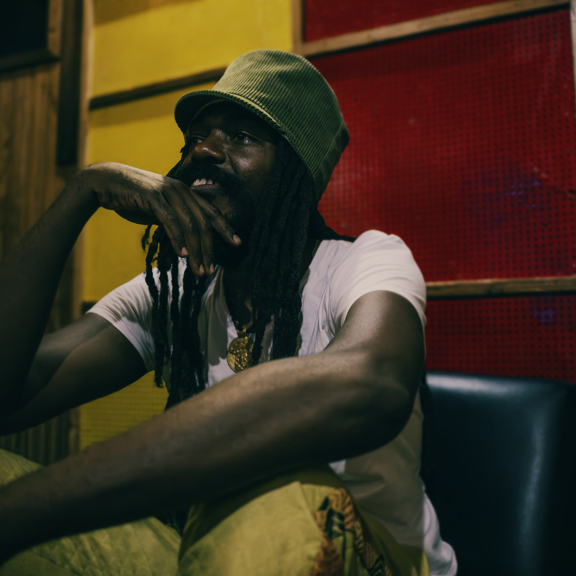 Jamaican bassie posing at Tuff Gong studio with a khaki corduroy dreadlocks hat