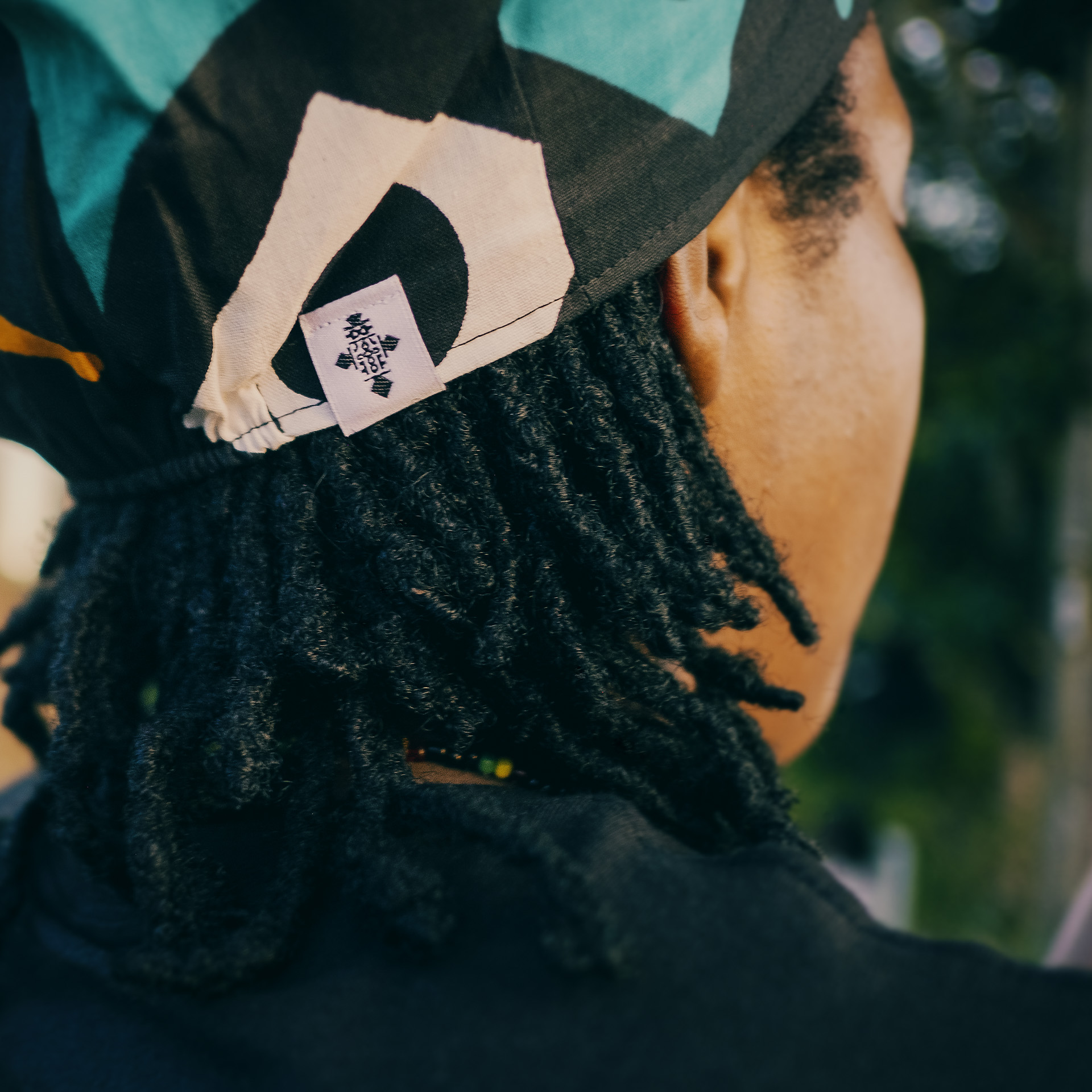 Close up of Claudette's dreadlocks with a Rasta hat