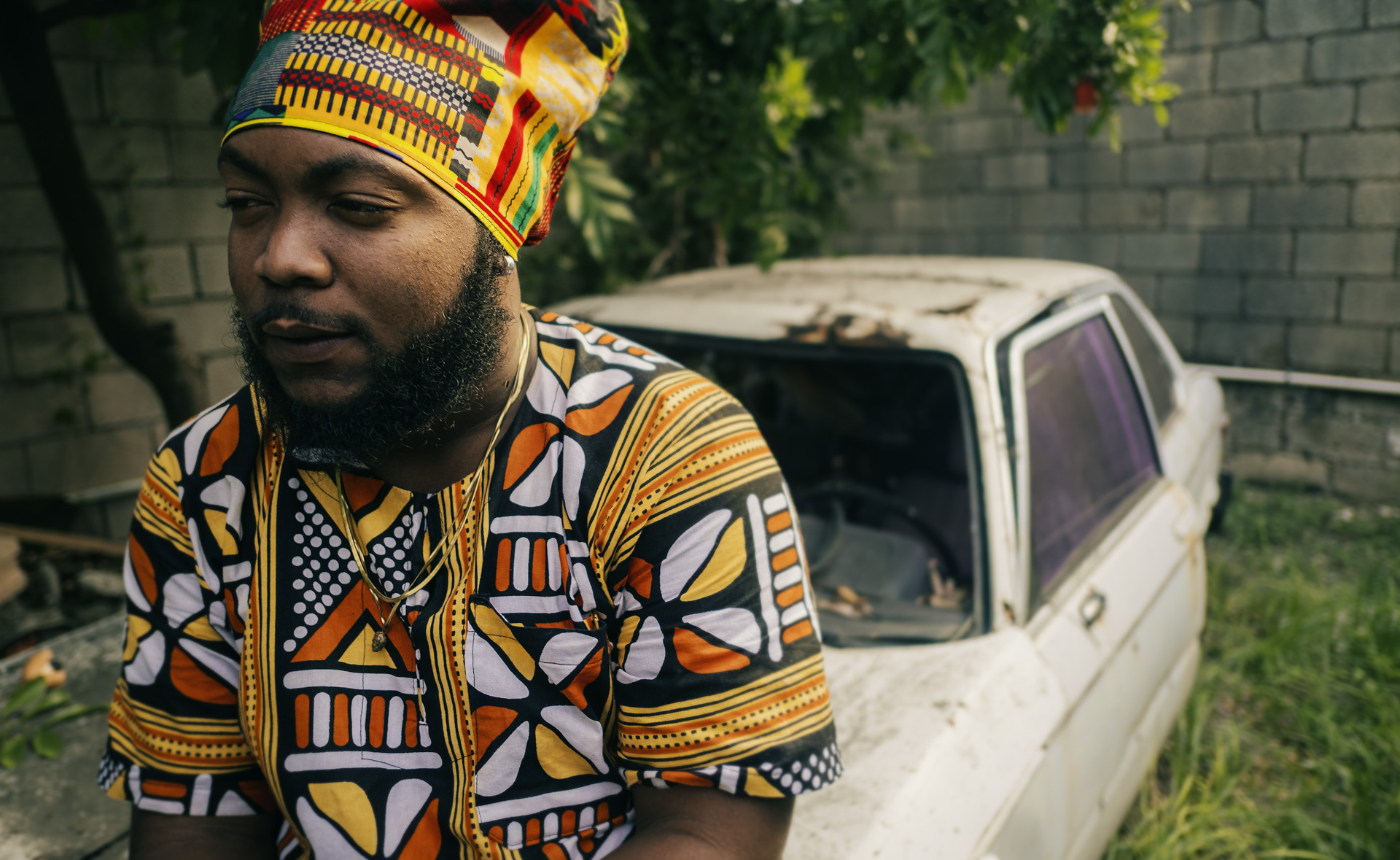 Jamaican artist posing with a Rasta hat for Dreadlocks Nation in Kingston