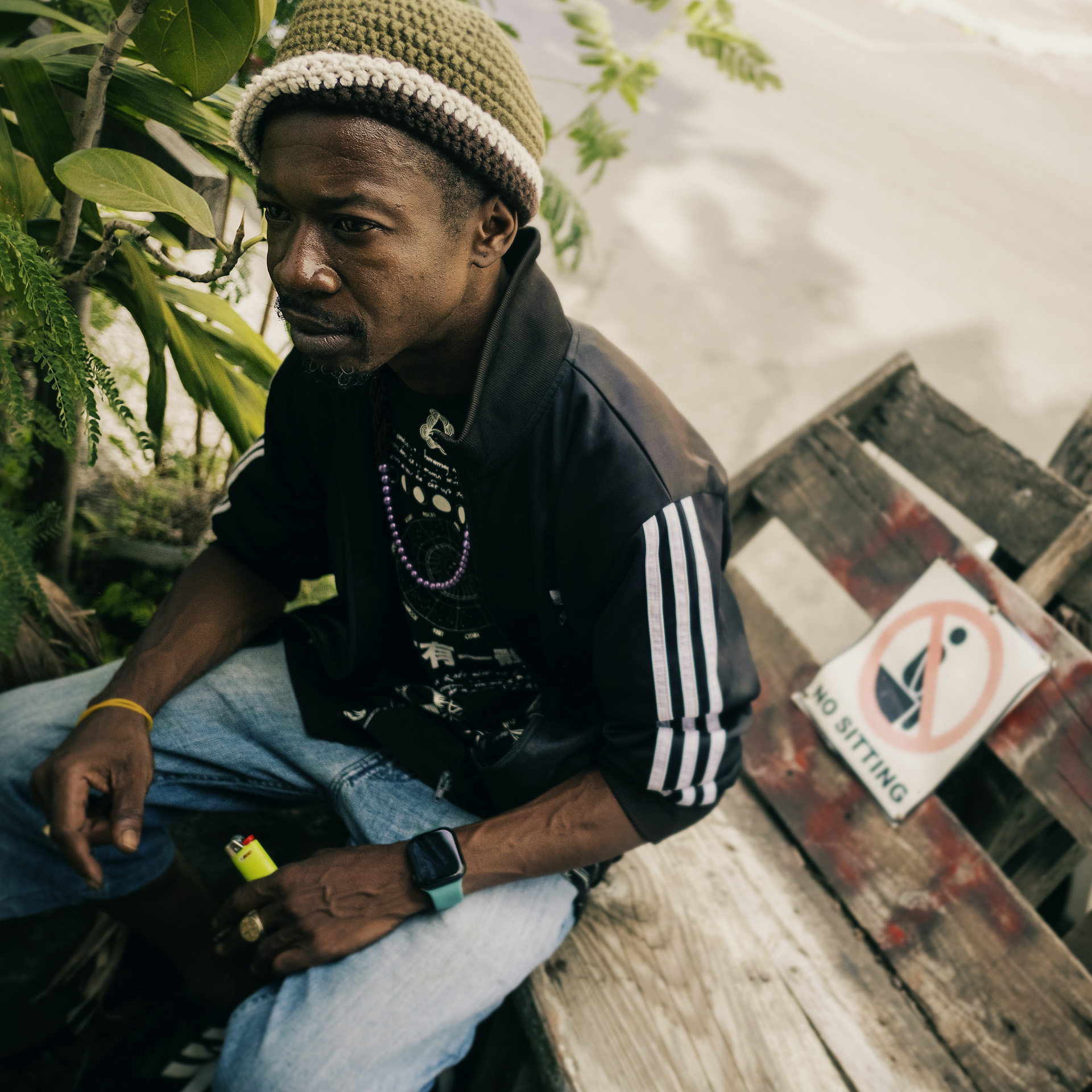Jamaican man with a green cream and brown wool Rasta hat