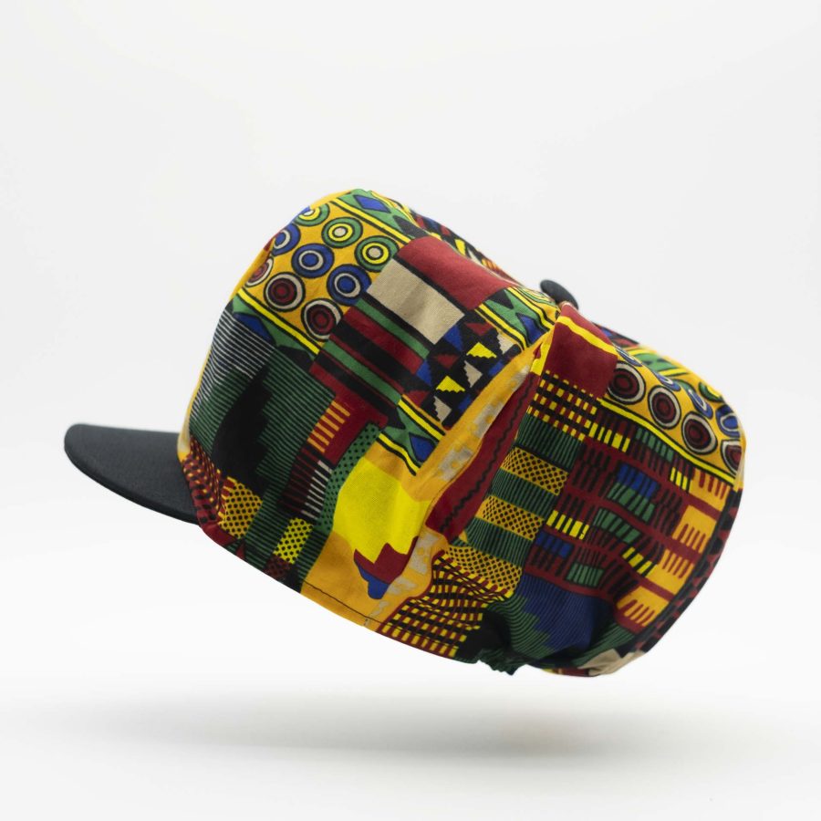 Rasta dreadlocks newsboy cap with black visor in light wax fabric with colorful African patterns, black lining