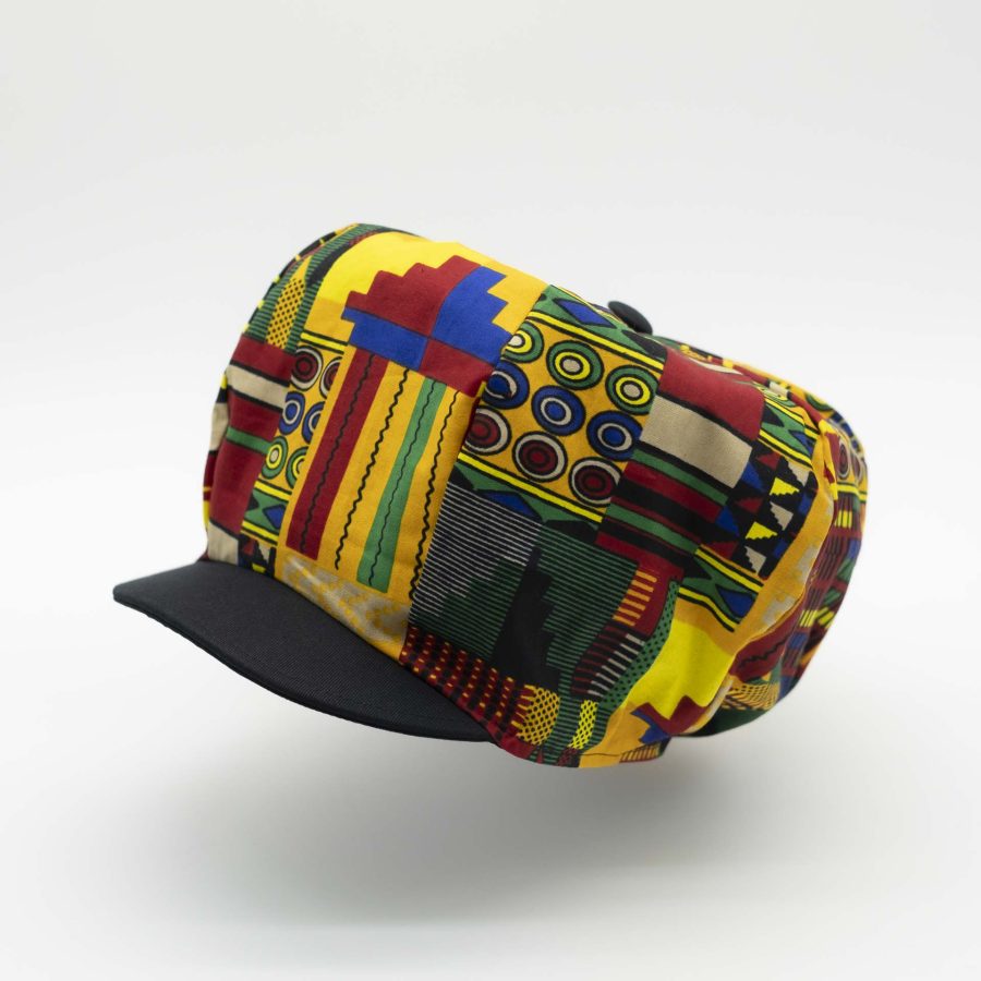 Rasta dreadlocks newsboy cap with black visor in light wax fabric with colorful African patterns, black lining