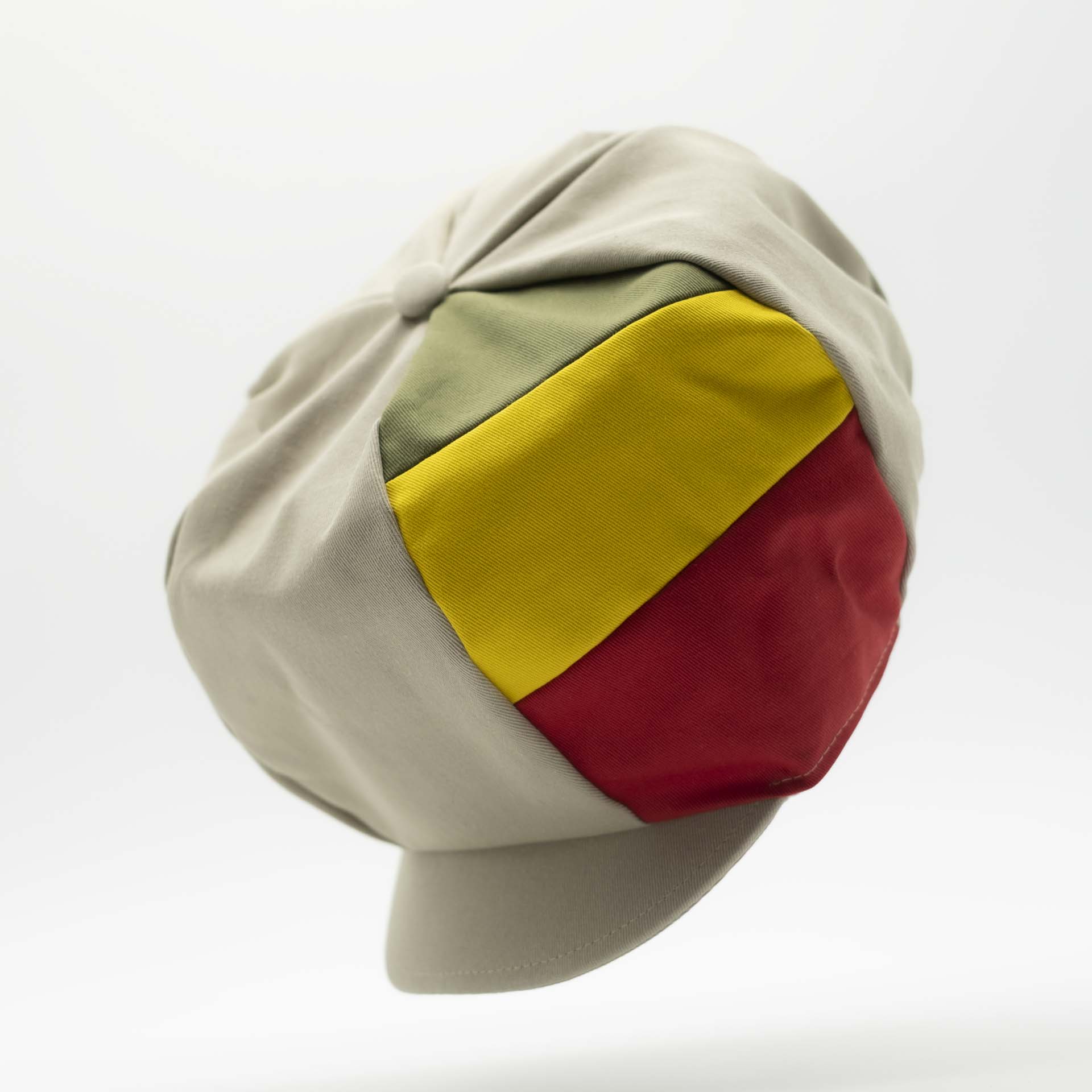 Rasta cap with visor for dreadlocks in beige cotton with three green yellow red stripes on one side of the hat and ecru lining