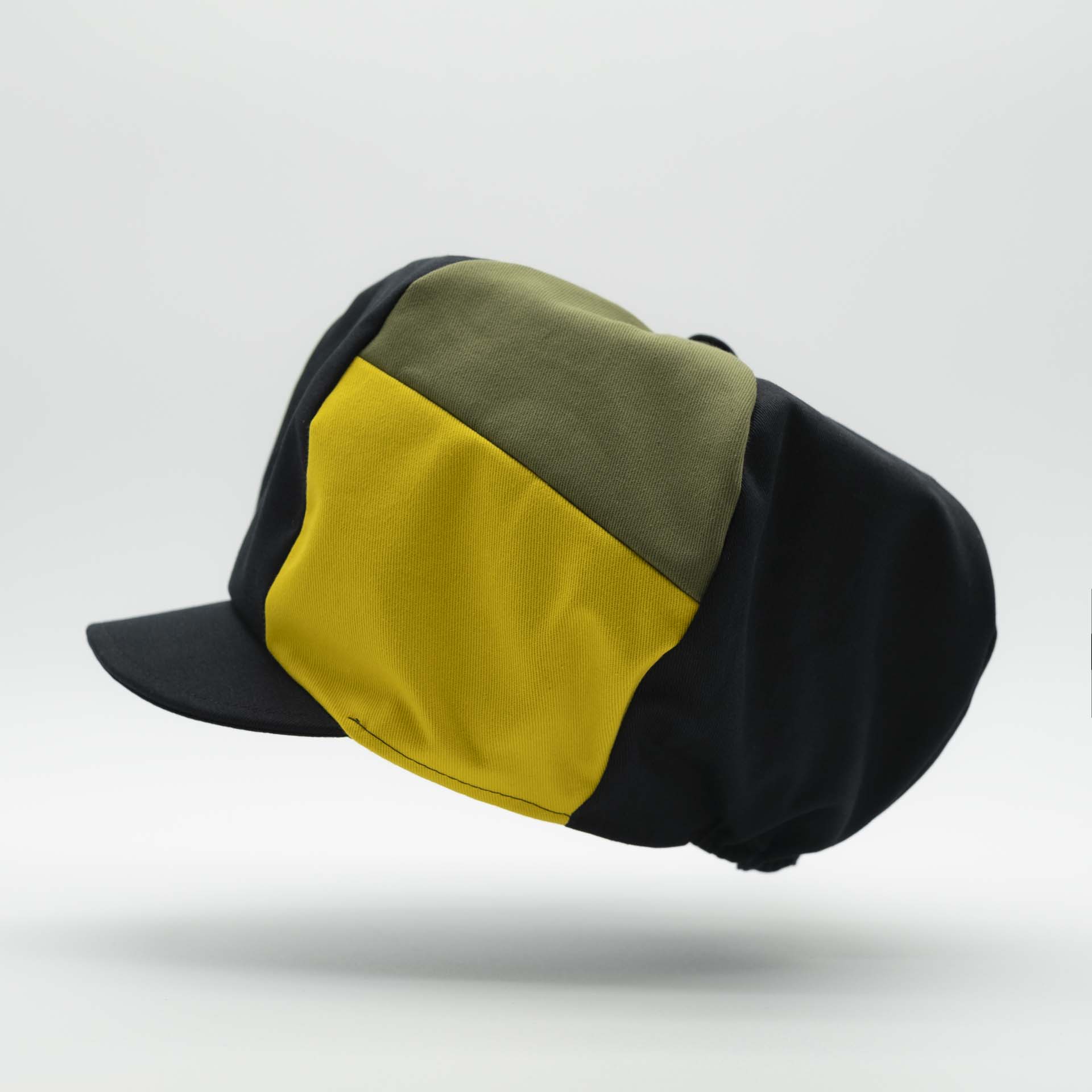 Rasta newsboy cap for dreadlocks with black cotton visor with two stripes green yellow colors of Jamaica on one side of the hat and black lining