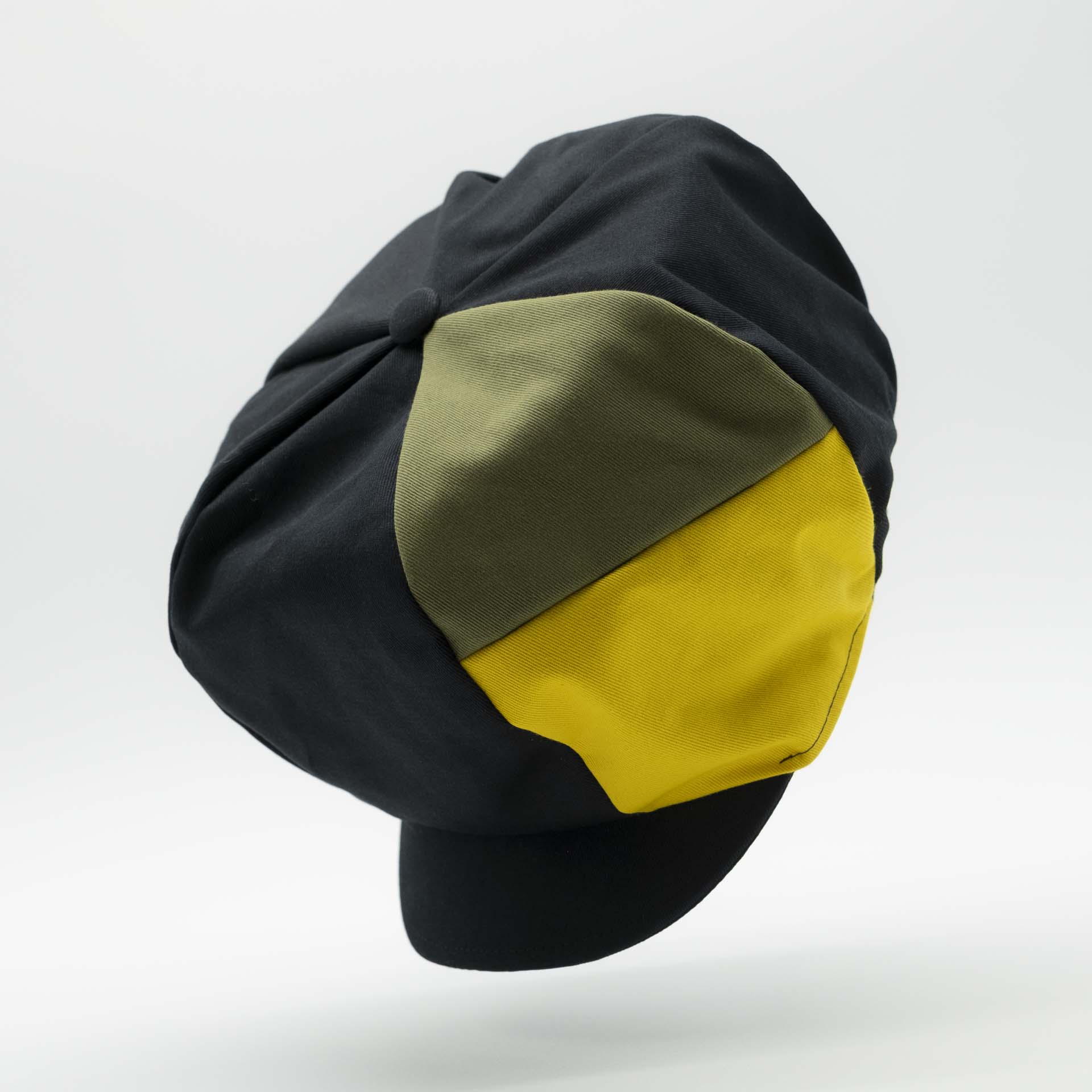 Rasta newsboy cap for dreadlocks with black cotton visor with two stripes green yellow colors of Jamaica on one side of the hat and black lining