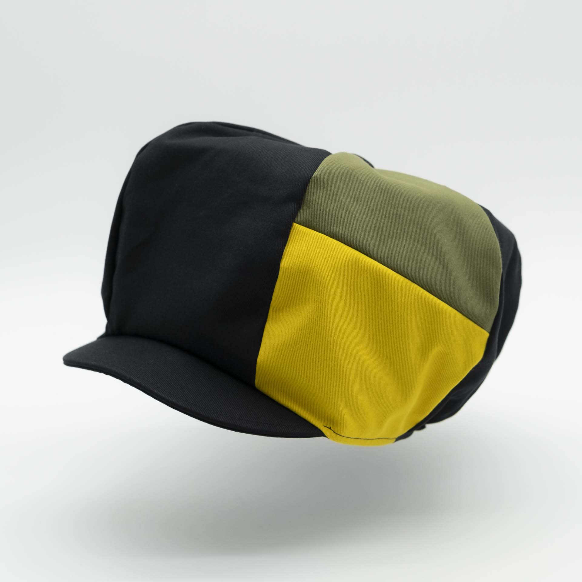 Rasta newsboy cap for dreadlocks with black cotton visor with two stripes green yellow colors of Jamaica on one side of the hat and black lining