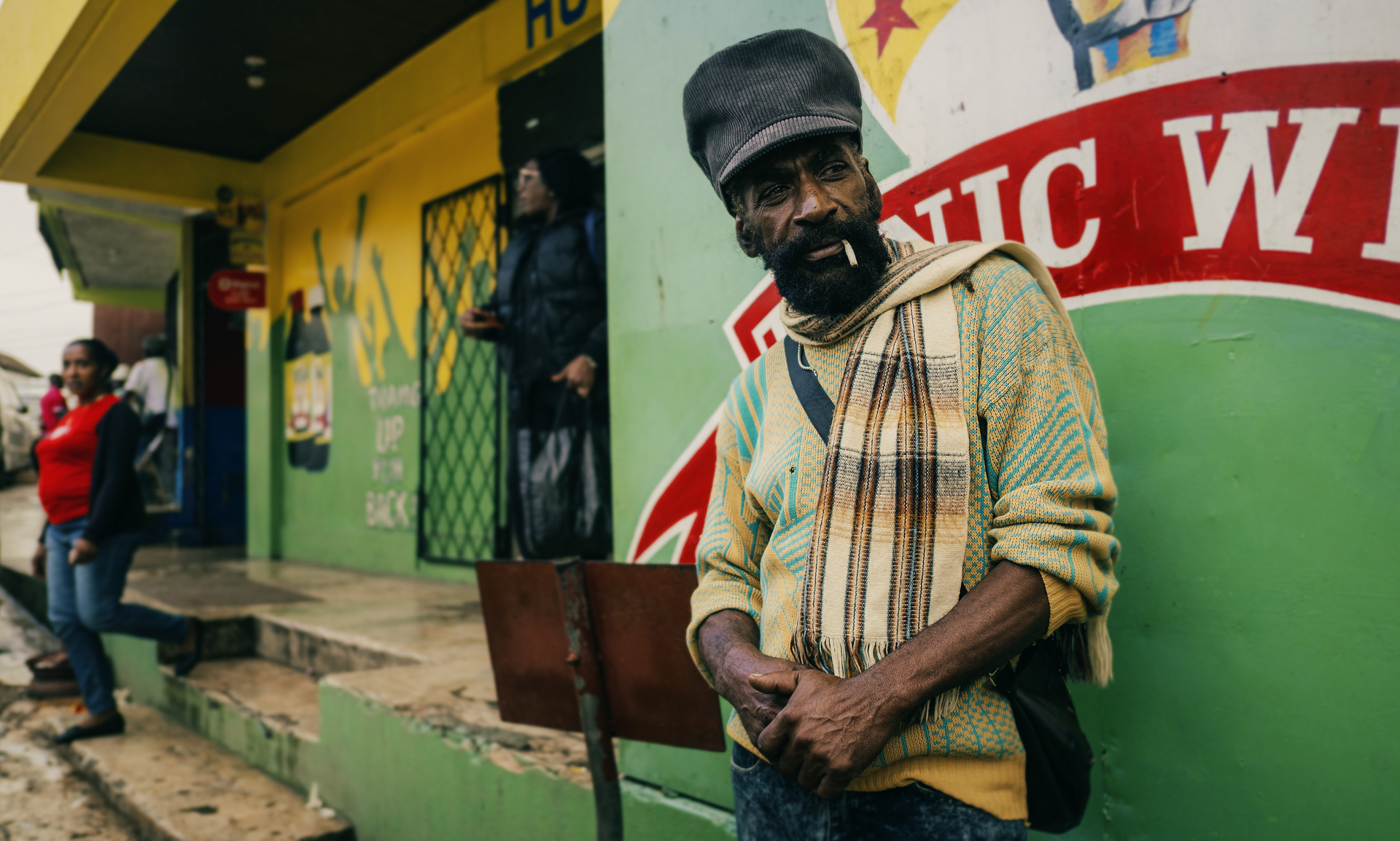 A man in the street wearing a black corduroy rasta cap from Jamrock collection