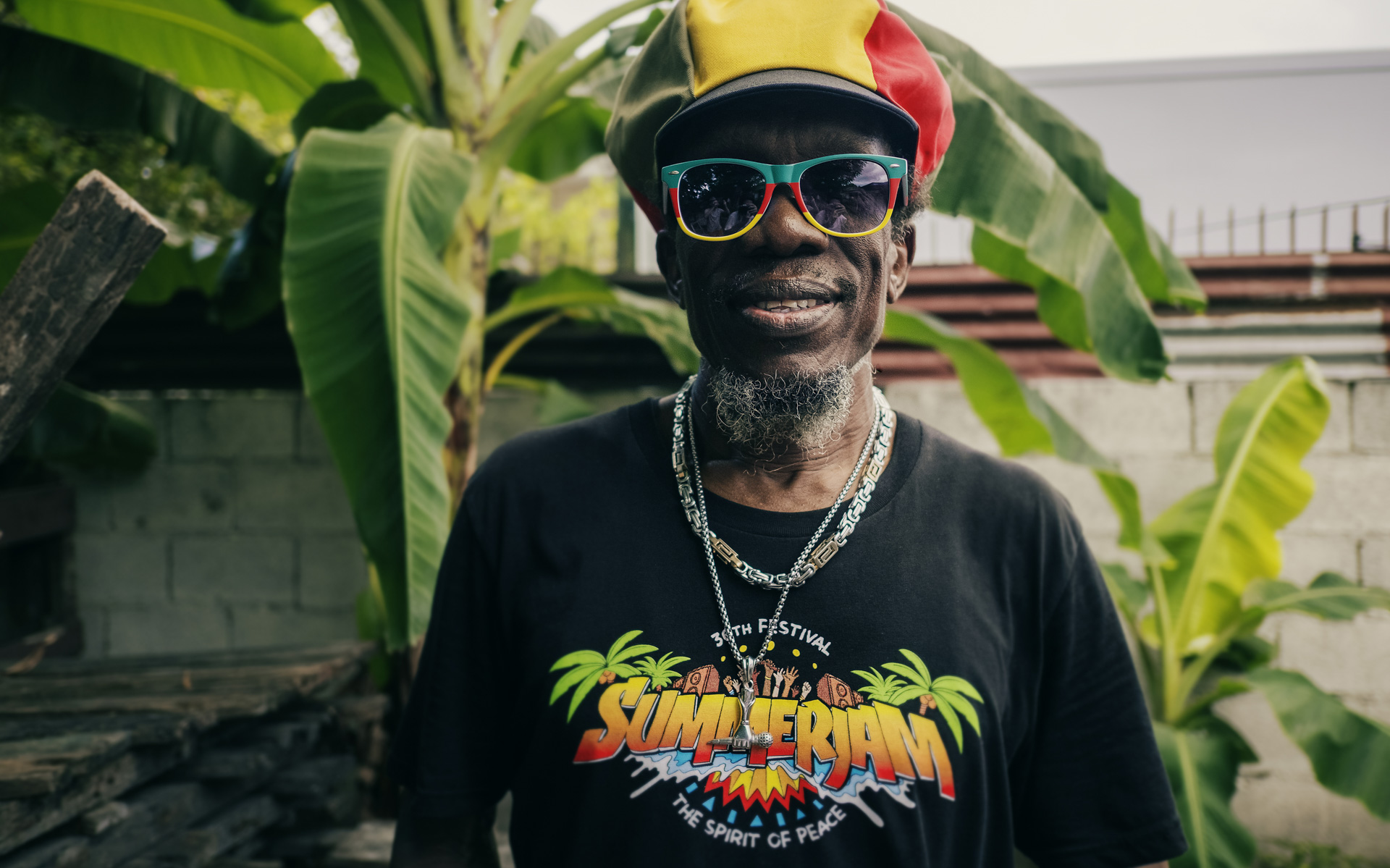 Alphonso from Inna De Yard with a red gold and green dreadlocks hat