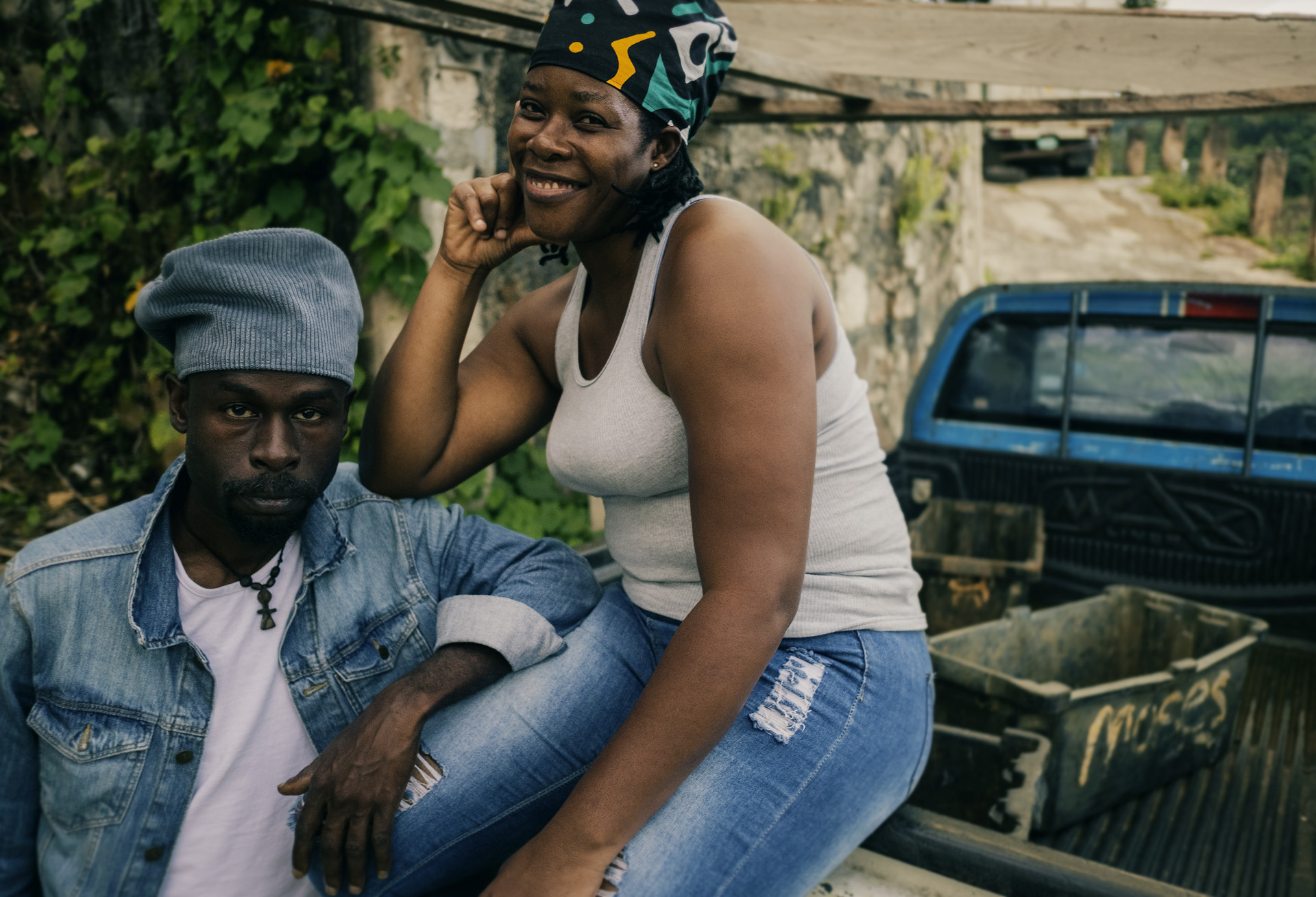 Jamaican friends posing together with dreadlocks hat