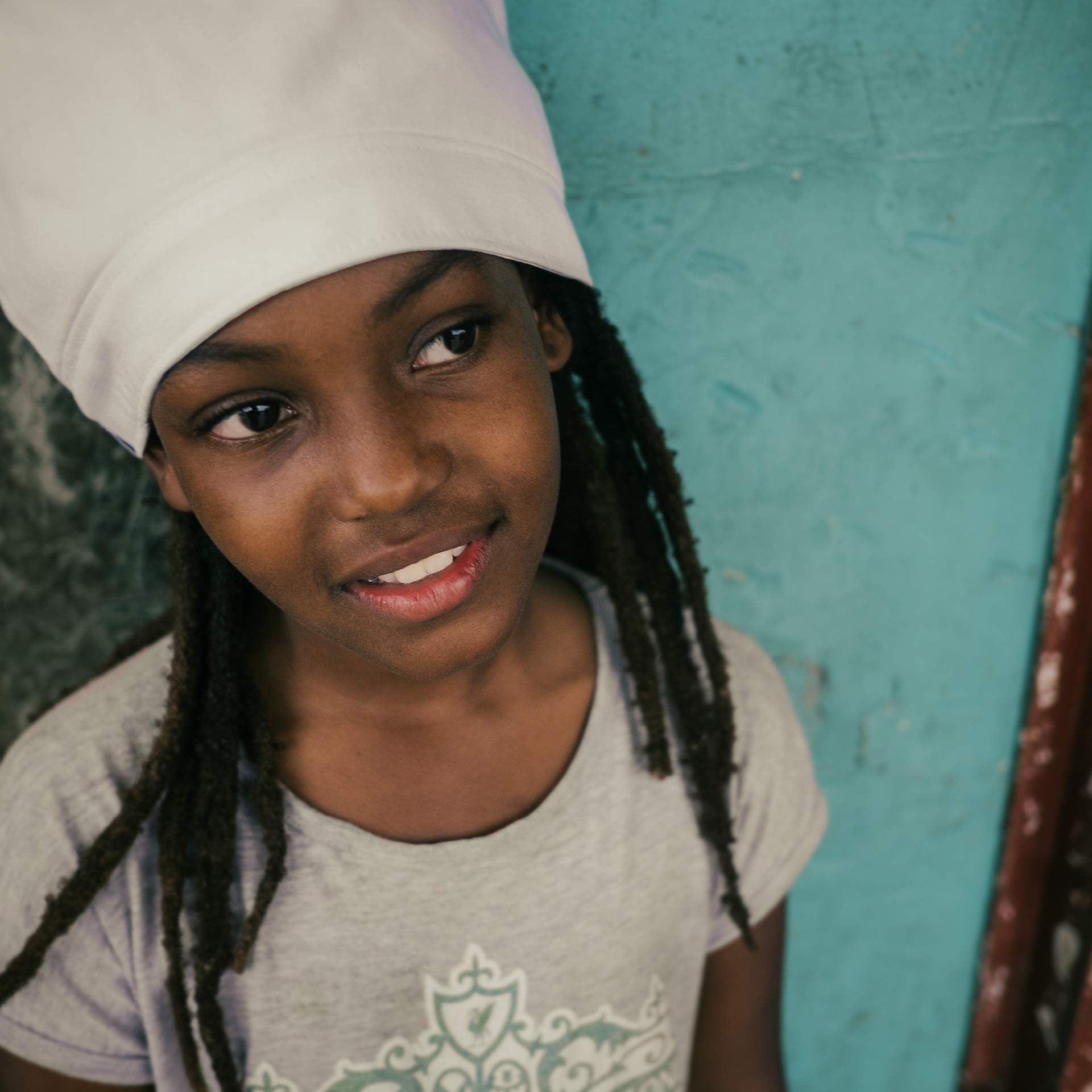 A beautiful Jamaican girl wearing a white dreadlocks crown